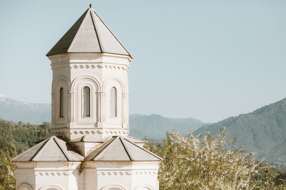 Ancient church tower with mountain backdrop