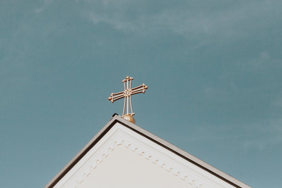 Golden cross clear blue sky