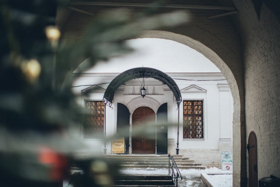 Historic archway snowy courtyard