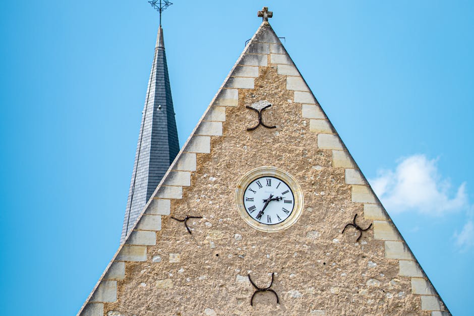 Historic tower clock under a blue sky