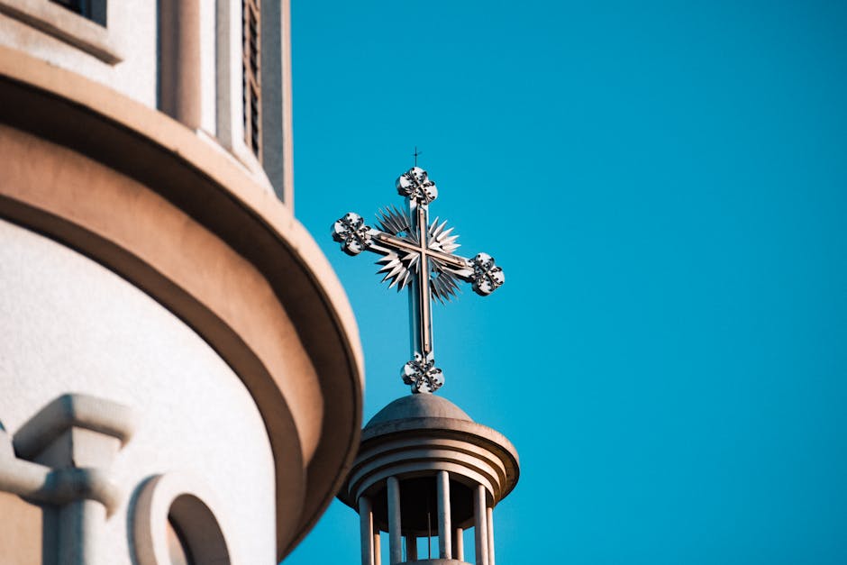 Ornate cross tower against a clear sky