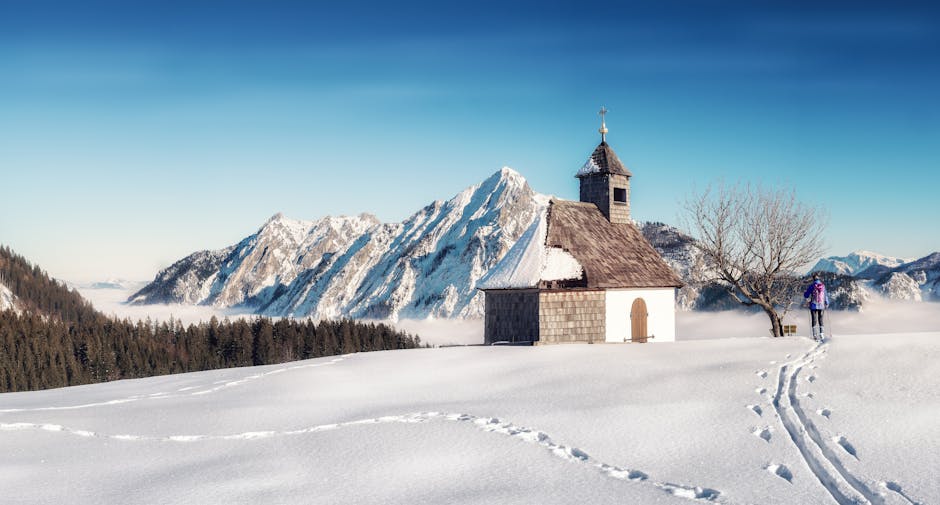 Snowy chapel mountain backdrop